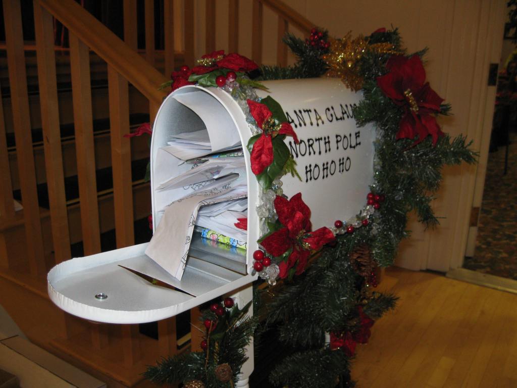 Mailbox decorated for Christmas and stuffed with kids letters to Santa.