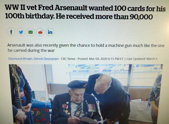 100 year old veteran reading cards he received